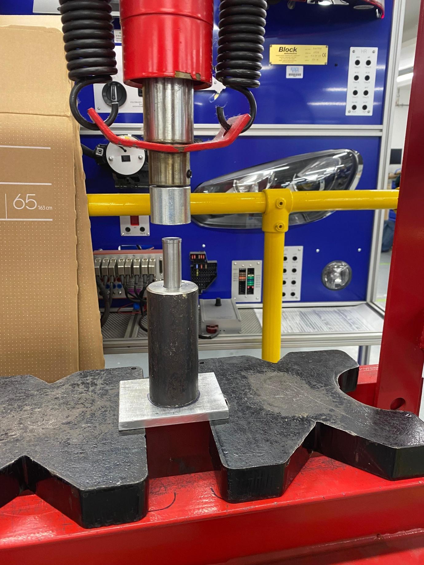 Laboratory press and specimen tooling documented in the lunar simulant research report
